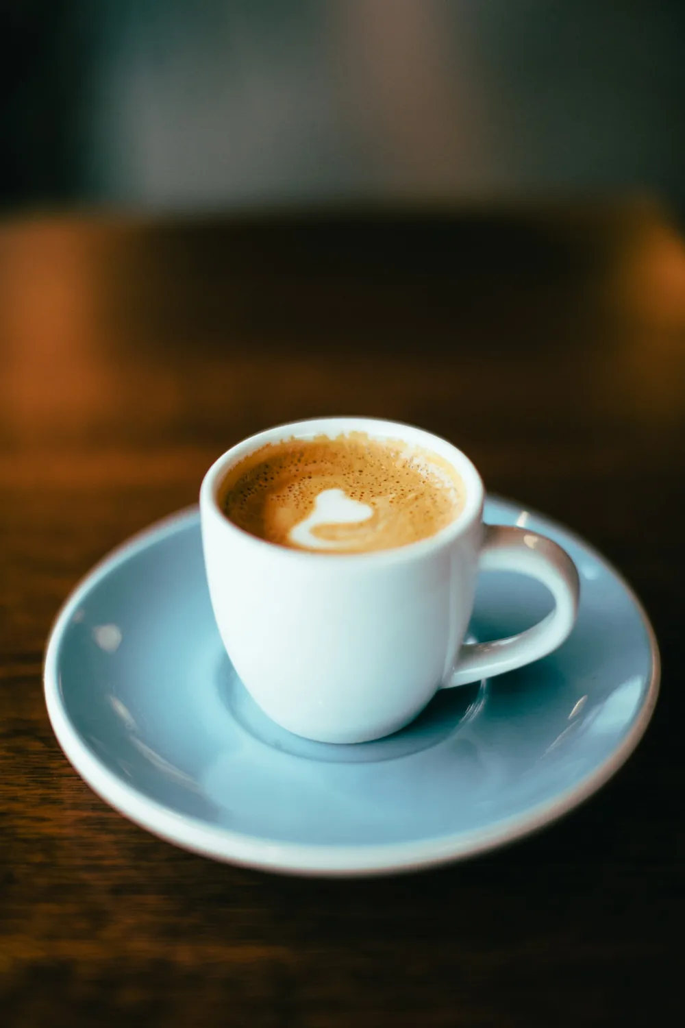 Espresso in a teal cup on a saucer